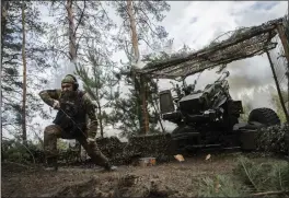  ?? TYLER HICKS — THE NEW YORK TIMES ?? A Ukrainian soldier with the 45th Separate Artillery Brigade fires a French TRF1155mm towed howitzer in the Donetsk province of Ukraine on Sunday.