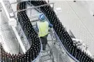  ??  ?? KEEPING TRACK: An Ibhayi Brewery employee works on the recycling packaging production line