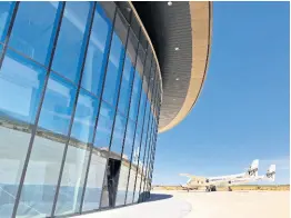  ??  ?? Virgin Galactic ground crew guide the company’s carrier plane into the hangar at Spaceport America following a test flight over the desert near Upham, New Mexico, on Thursday, August 15, 2019.