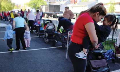  ?? Photograph: Brian Snyder/Reuters ?? Parents and children in Chelsea, Massachuse­tts. Supplies of baby formula across the country have been severely curtailed in recent weeks.