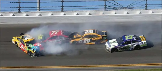  ?? JERRY MARKLAND, GETTY IMAGES ?? Kyle Busch (18), Erik Jones (77), Matt Kenseth (20) and Ty Dillon (13) are involved in the first multi-car crash at Sunday’s 59th running of the Daytona 500.