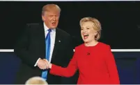  ?? (Mike Segar/Reuters) ?? US PRESIDENTI­AL candidates Donald Trump and Hillary Clinton shake hands after their debate in Hempstead, New York, on Monday night.