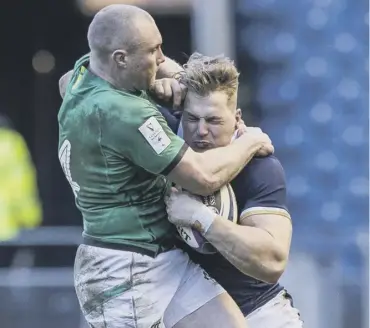  ??  ?? 0 Ireland’s Keith Earls, left, and Duhan van der Merwe of Scotland clash