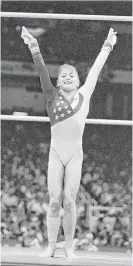  ?? Doug Pensinger / Allsport ?? Dominique Moceanu learned about the ups and downs of life during her successful gymnastics career.