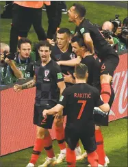  ?? Jewel Samad / AFP/Getty Images ?? Croatia forward Ivan Perisic, center, celebrates with teammates after scoring his team’s first goal during Wednesday’s semfinal against England.