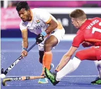  ?? — AFP ?? Amit Rohidas (left) of India and Sam Ward of England fight for the ball during their match on Wednesday.