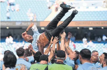  ??  ?? Manchester City manager Pep Guardiola is tossed by his players after they won the Premier League in 2018.