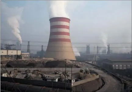  ?? NG HAN GUAN — THE ASSOCIATED PRESS FILE ?? Smoke and steam rise from the sprawling complex that is a part of the Jiujiang steel and rolling mills in Qianan in northern China’s Hebei province.