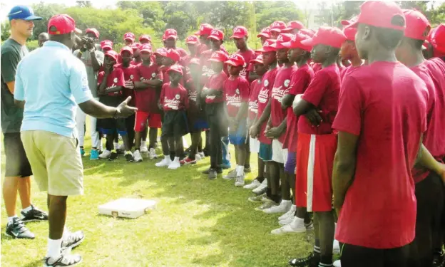  ??  ?? A former US Major Baseball League star Jeremy Guthrie and a member of Nigeria baseball federation addressing the kids during the clinic in Abuja