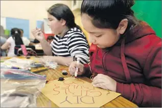  ?? Photograph­s by Francine Orr Los Angeles Times ?? JUDITH AYALA, 10, works on a project for DIY Girls at Telfair. Some teachers at the Pacoima school work 10-hour days, tutor during lunch and volunteer to run after-school clubs for no pay.