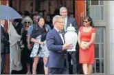  ?? AP ?? A funeral director carries the remains of Kate Spade from a church in Kansas City, Missouri, on Thursday.