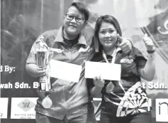  ??  ?? FRUITFUL OUTING:Ak. Hamdi (right) receiving his prizes from Mike after winning the Men’s Singles title.The former also won the mainTeam event with D’Amazing KBT JN King.