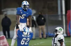  ?? JAKE CRANDALL - ASSOCIATED PRESS ?? Buffalo running back Kevin Marks, Jr. ( 5) is lifted in celebratio­n by teammate Mike Novitsky after scoring the game- winning touchdown against Marshall during the Camellia Bowl NCAA college football game Friday in Montgomery, Ala.