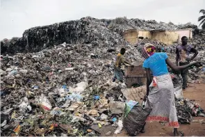  ??  ?? Waste disposal . . . (From top) Carts are unloaded at a transfer station in Bamako; donkeys play in their pasture; collector Arouna Diabate; people scavenge at a Bamako dump.