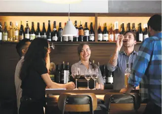  ?? Liz Hafalia / The Chronicle ?? Alta MSP service manager Lyndsey Palkovic (middle) and beverage director Aaron Paul (to her right) taste wines with staff at the restaurant next door to Minnesota Street Project.