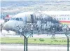  ?? PHOTO: REUTERS ?? Rescue workers are seen at the site where an Airbus A319 plane of Tibet Airlines caught fire after an aborted takeoff at Chongqing Jiangbei Internatio­nal Airport, in Chongqing, China, yesterday. All passengers and crew were evacuated, the South China Morning Post reported, but 36 people were taken to hospital with minor injuries.