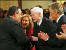  ?? RICH SCHULTZ — THE ASSOCIATED PRESS FILE ?? In this file photo, former New Jersey Gov. Brendan Byrne, center, shakes hands with New Jersey Gov. Chris Christie, left, as Byrne’s wife Ruthi Zinn Byrne, second from left, and former New Jersey Gov. James Florio, right, clap after Christie outlined...