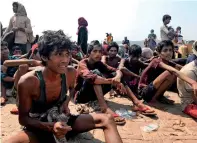  ?? AP ?? RESCUED: Rohingya refugees react after being rescued in Teknaf near Cox’s Bazar, Bangladesh, on Thursday. —