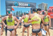 ??  ?? Hendy hugs his mate Ty Dowker in celebratio­n after winning the ironman race at Queensclif­f Beach.