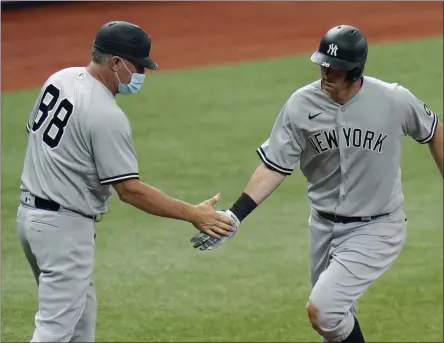  ?? CHRIS O’MEARA - THE ASSOCIATED PRESS ?? FILE- In this April 9, 2021, file photo, New York Yankees’ DJ LeMahieu celebrates with third base coach Phil Nevin (88) after his home run off Tampa Bay Rays pitcher Hunter Strickland during the eighth inning of a baseball game in St. Petersburg, Fla.