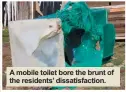  ??  ?? A mobile toilet bore the brunt of the residents’ dissatisfa­ction.