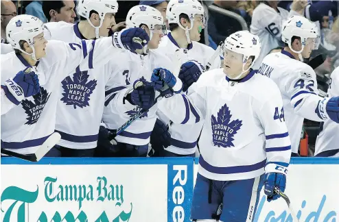  ?? CHRIS O’MEARA / THE ASSOCIATED PRESS ?? Toronto Maple Leafs defenceman Morgan Rielly celebrates with the bench after scoring against the Tampa Bay Lightning during NHL action Thursday in Tampa. The Leafs were 5- 0 winners.