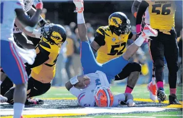  ?? DENNY MEDLEY/USA TODAY SPORTS ?? Gators QB Tyler Murphy is sacked by the Missouri defense. He struggled to move the ball all day and was sacked 6 times.