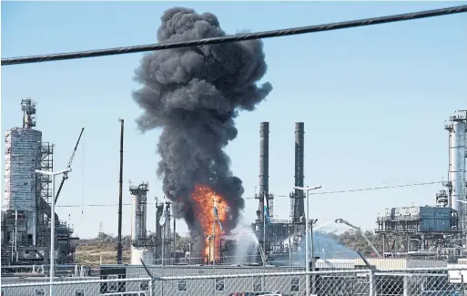  ?? STEPHEN MACGILLIVR­AY PHOTOS THE CANADIAN PRESS ?? Flame and smoke erupts from the Irving Oil refinery in Saint John, N.B., on Monday. Residents described feeling an explosion shortly after 10 a.m.