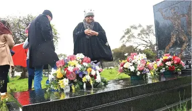  ?? PICTURE: COURTNEY AFRICA/ANA PICTURES ?? CLOSURE: Michelle Assure and others pay tribute to Ashley Kriel at his grave as they commemorat­e the 30th anniversar­y of his death. A documentar­y Action Komandant has been made about his life by film director Nadine Cloete.