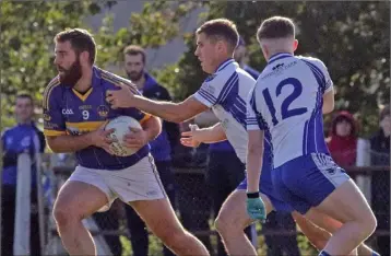  ??  ?? Conor Cafferkey of St. Mary’s (Rosslare) shakes off Craanford’s Michael Shortall and Jim Redmond.