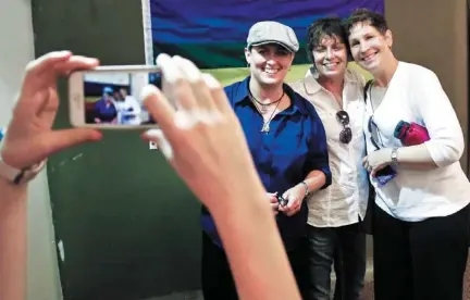  ?? PHOTO BY CHRIS LANDSBERGE­R, THE OKLAHOMAN ?? Jonnette Lynn, Teresa Lynn and Kathy Carson, from left, have their picture taken Wednesday during a rally at the Cimarron Alliance Equality Center in Oklahoma City to celebrate the U.S. Supreme Court’s rulings that struck down the federal Defense of...