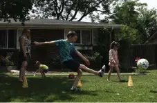  ?? Rachel Ellis, The Denver Post ?? The Nidy family plays in the front yard of their Arvada home. Brittany and Greg Nidy are not sure if Jefferson County’s plan to return to in-school learning is the best choice for their children.