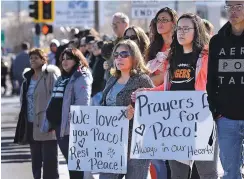  ?? JIM THOMPSON/THE ALBUQUERQU­E JOURNAL VIA AP ?? Mother and daughter Michelle and Monica Valencia hold signs Friday as they stand with other supporters along Piñon Hills Boulevard in Farmington while the funeral procession for Francisco ‘Paco’ Fernandez passes. Fernandez, 17, was killed Dec. 7 when...