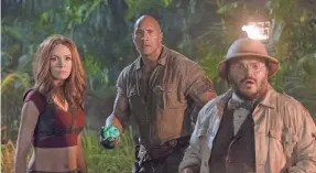  ??  ?? From left, Karen Gillan, Dwayne Johnson and Jack Black find danger in a videogame world in “Jumanji: Welcome to the Jungle.” SONY PICTURES ENTERTAINM­ENT