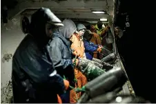  ?? ?? Indonesian fishermen work on board the ‘O Fugitivo’ Portuguese fishing boat, off the coast of the small coastal village of Caxinas, north of Porto.