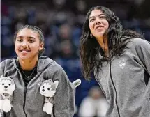  ?? Jessica Hill/Associated Press ?? UConn’s Azzi Fudd, left, and newest addition to the team Jana El Alfy, right, of Egypt, watch their team warm up before a game against DePaul on Jan. 23 in Storrs.