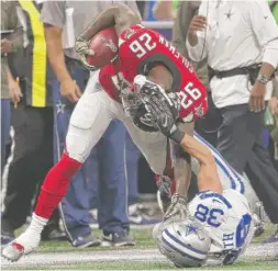  ?? | JOHN BAZEMORE/ AP ?? Cowboys strong safety Jeff Heath ( 38) tackles running back Tevin Coleman by the helmet during the first half of the Falcons’ victory.