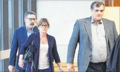  ?? CP PHOTO ?? Rail traffic controller Richard Labrie (right), Manager of train operations Jean Demaitre (left) and his wife, Danielle Champagne, return to the courtroom to hear the verdict on the ninth day of deliberati­ons Friday in Sherbrooke, Que.
