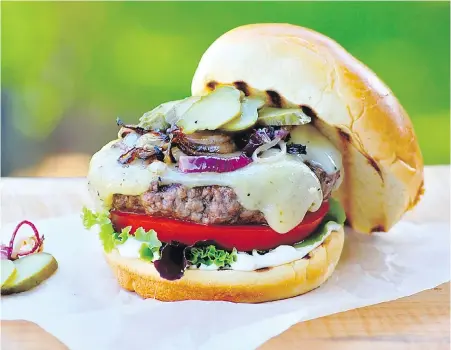  ?? ERIC AKIS ?? Island-raised beef, locally baked buns and Island-sourced cheeses are the centrepiec­e of this juicy burger.