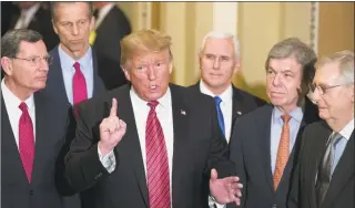  ?? Alex Brandon / Associated Press ?? Sen. John Barrasso, R-Wyo., left, and Sen. John Thune, R-S.D., stand with President Donald Trump, Vice President Mike Pence, Sen. Roy Blunt, R-Mo., and Senate Majority Leader Mitch McConnell of Ky., as Trump speaks after a Senate Republican Policy luncheon on Capitol Hill on Wednesday.