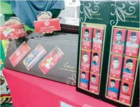  ??  ?? Umno chocolate bars for sale during the general assembly. The packaging features photograph­s of Umno leaders.