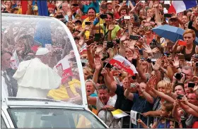  ?? AP/CZAREK SOKOLOWSKI ?? Pope Francis salutes the crowd Wednesday on his way to Wawel Castle in Krakow, Poland.