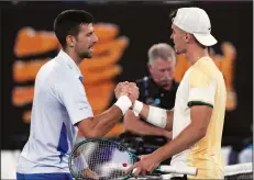  ?? (AP/Andy Wong) ?? Serbia’s Novak Djokovic (left) shakes hands with Croatia’s Dino Prizmic following their first-round match Sunday at the Australian Open at Melbourne Park in Melbourne, Australia. The 18-year-old Prizmic had never played a Grand Slam match, but it took the 24-time major champion Djokovic 4 hours to beat him.