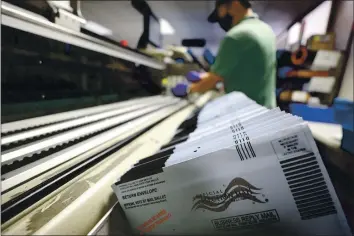  ?? PHOTO BY JUSTIN SULLIVAN — GETTY IMAGES ?? Mail-in ballots sit in a sorting machine at the office of County of Santa Clara Registrar of Voters on Oct. 13. The registrar is preparing to take in and process thousands of ballots with early voting underway in California.