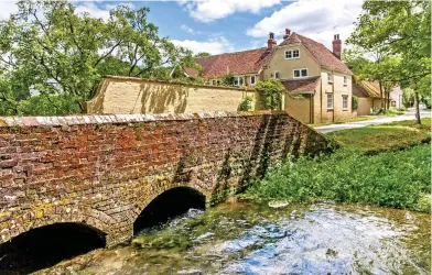  ??  ?? Go with the flow: High Barn in Hampshire comes with fishing rights to the River Meon