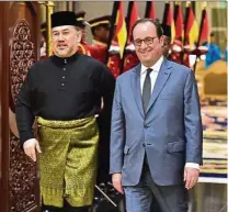  ??  ?? Sultan Muhammad V and then French president Francois Hollande arriving for a state dinner with the Malaysian monarch at Istana Negara in March this year. — AFP