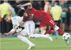  ?? AP ?? Sergio Ramos pulls Mohamed Salah to the ground in the incident that left the Liverpool striker with a dislocated shoulder