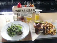  ?? LESLEY CHESTERMAN/ THE GAZETTE ?? Prohibitio­n Pig’s menu includes a salad of arugula, farro and grilled Brussels sprouts, and an outstandin­g hamburger.