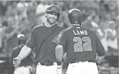  ?? PATRICK BREEN/AZCENTRAL SPORTS ?? The Diamondbac­ks’ Paul Goldschmid­t greets Jake Lamb at home plate after his two-run home run against the Rockies at Chase Field on April 29.