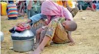  ?? AFP ?? An elderly Rohingya refugee is asleep while holding her sleeping grandson in her lap at Kutupalong refugee camp in Ukhiya after crossing the border from Myanmar into Bangladesh. —